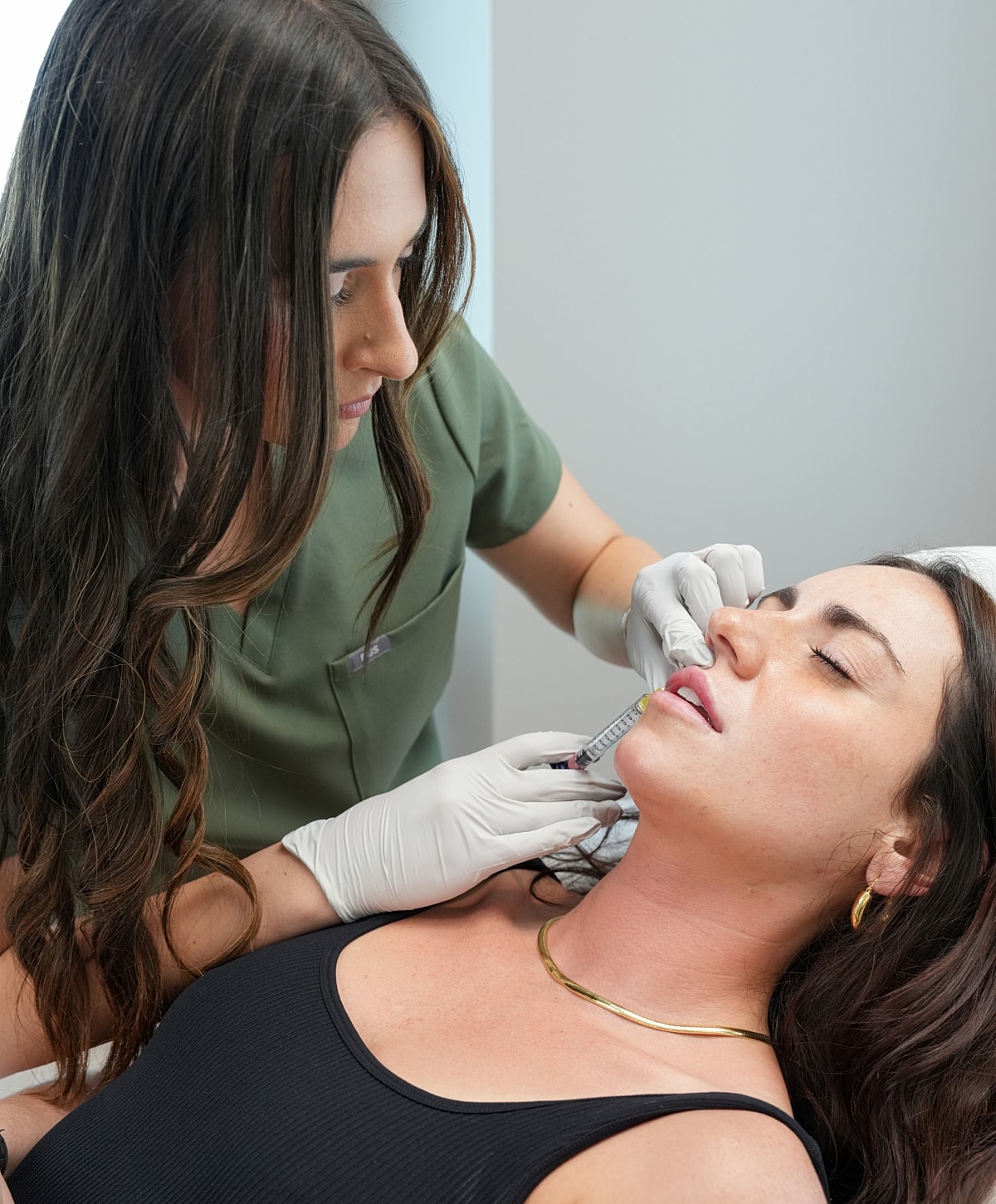 Cosmetic procedure: woman receiving lip injections.