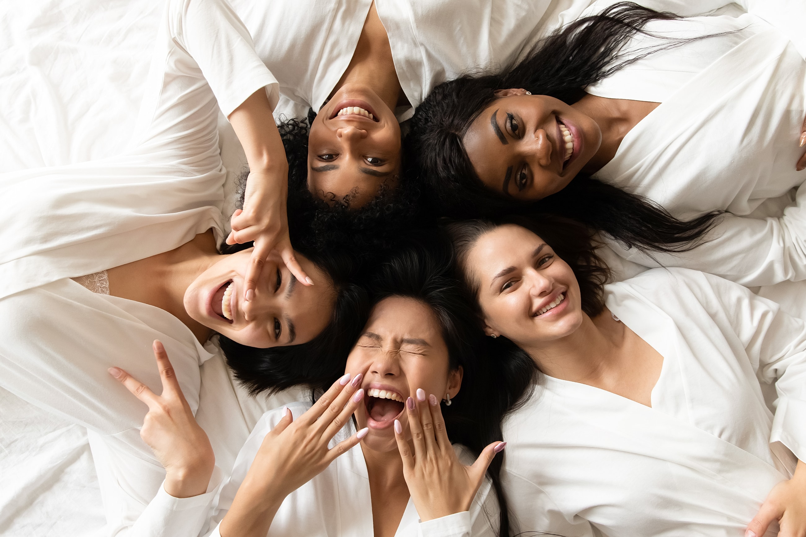 Friends enjoying time together in cozy robes.